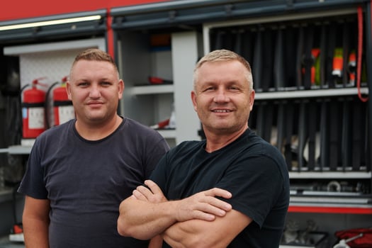 A skilled and dedicated professional firefighting team proudly poses in front of their state of the art firetruck, showcasing their modern equipment and commitment to ensuring public safety. photo