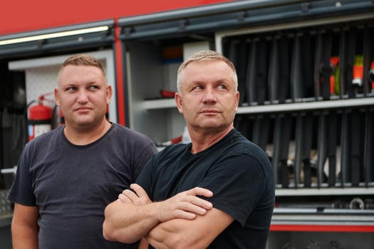 A skilled and dedicated professional firefighting team proudly poses in front of their state of the art firetruck, showcasing their modern equipment and commitment to ensuring public safety. photo
