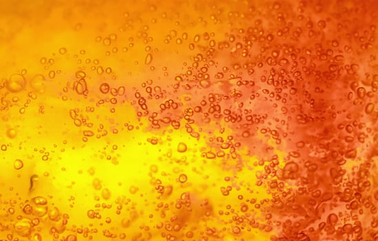 Vibrant Yellow and Orange Liquid with Bubbles, Abstract Textured Gel Background photo