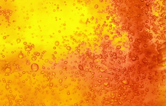 Vibrant Yellow and Orange Liquid with Bubbles, Abstract Textured Gel Background photo