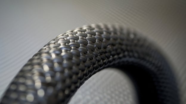 A close inspection of a rubber hoses end shows the precision molding of its curved edges and the strength of its thick walls photo