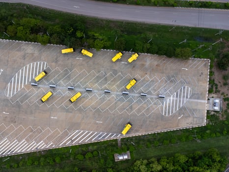 Aerial view of the electric bus charging station. Yellow electric city bus charging parking at charger station with plug cable. Electrified transport future mobility e-motion. photo