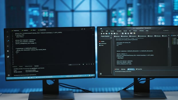 Computers in empty data center facility managing rackmounts energy consumption. Close up of script on PC monitors used for automation and monitoring processes in server room, camera B photo
