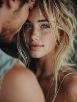 Close Up Portrait of a Woman Looking Into the Camera With Her Partners Arm Around Her photo