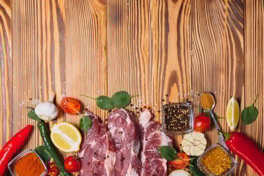 Raw pork chop steak prepare in kitchen with vegetable and spices for food and cooking concept photo