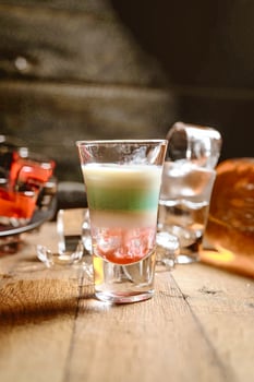 Wooden Table With Glasses of Liquid photo