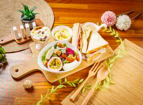 Vegetable and Fruit Salad with dragon fruit, passion fruit, cabbage, lettuce and tomato, club sandwich and Tofu Pudding served in dish isolated on wooden table side view of taiwan food photo