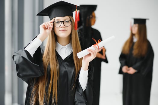Pretty female college graduate at graduation with classmates photo