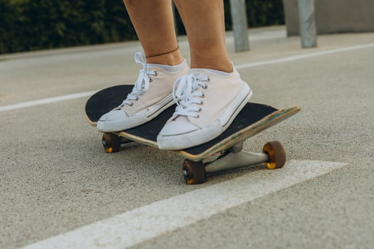 close up of skateboarders foot while skating photo