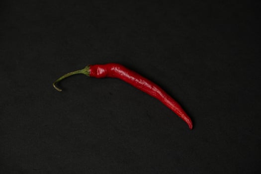 red chillies on the dark table photo