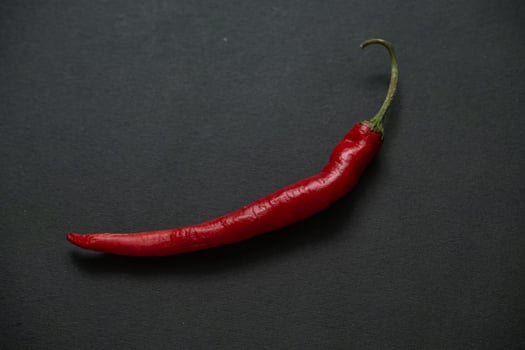 red chillies on the dark table photo