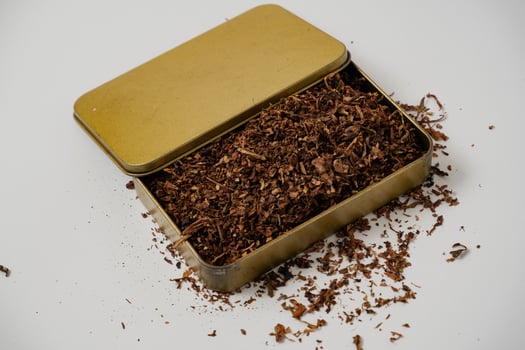 fine tobacco in a gold box with a white background photo