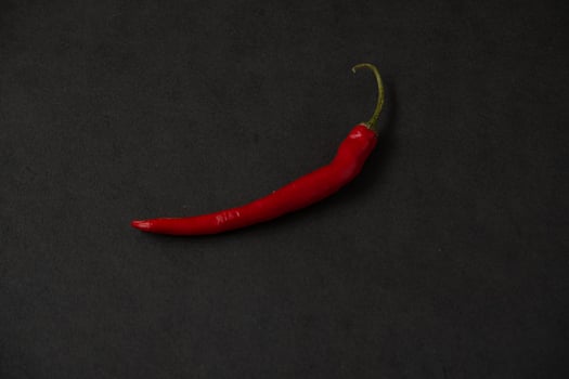 red chillies on the dark table photo