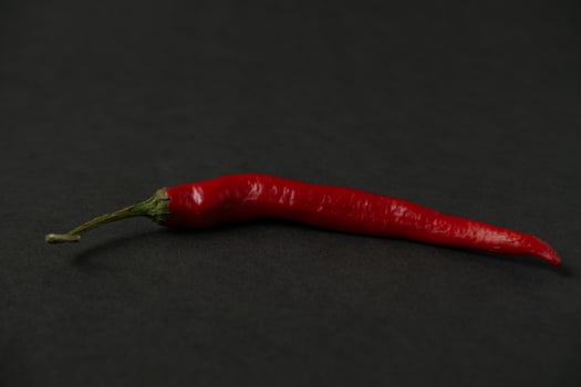 red chillies on the dark table photo