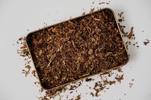 fine tobacco in a gold box with a white background photo