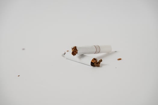 a broken cigarette on a white background photo