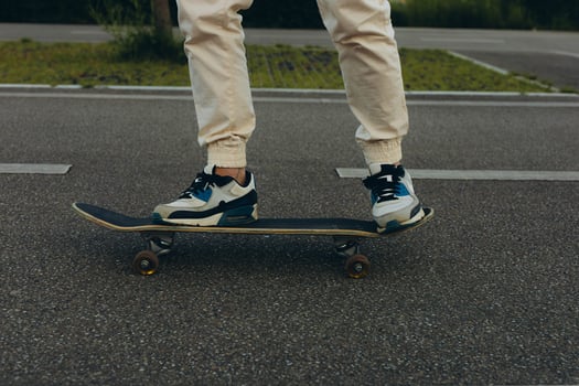 Closeup man feet riding in sporty shoes hipster balancing on skateboard photo