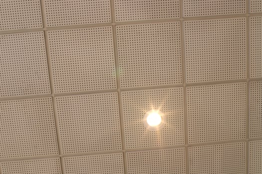 A lamp for illuminating the interior of the room hangs on the ceiling. photo