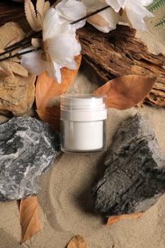 Elegant White Jar with Natural Elements on Sandy Background photo