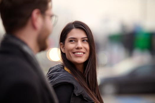 A romantic couple embraces in a tender hug as they stroll through the city streets, enjoying leisure time together in each other's company photo