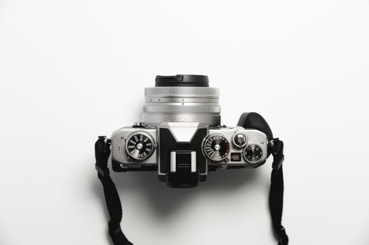 modern camera in retro style with a strap close-up, top view photo