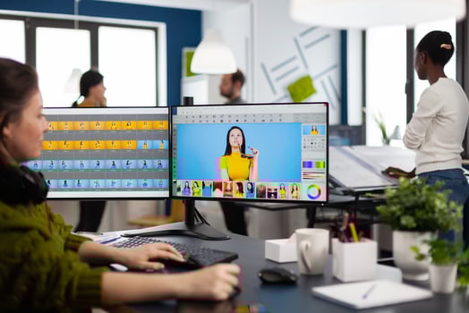 Freelancer retoucher woman working on computer with photo editing software. Professional graphic editor retouching assets of client with stylus pencil and two monitors in creative multimedia company