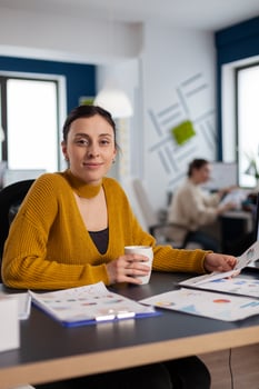 Company leadership orf financial company looking at camera holding documents with charts Executive entrepreneur, manager leader sitting working on projects with diverse colleagues. photo