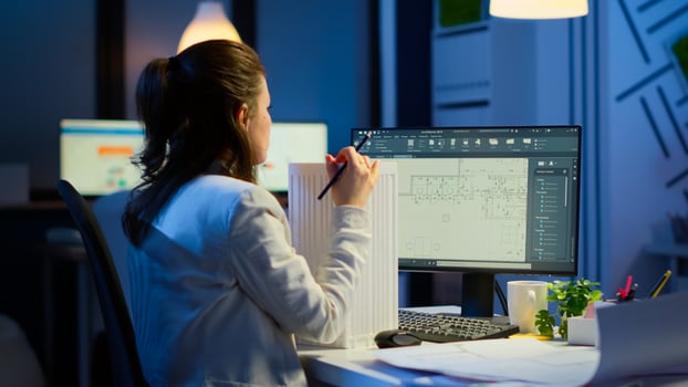 Engineer constructor designer architect creating new component in CAD program working in business office. Industrial woman employee studying prototype idea showing cad software on device display photo