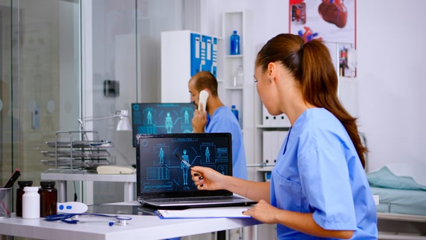 Student medical practitioner analysing human body digital scan, holding radiography sitting in hospital. Radiologist in medicine uniform looking at x-ray, examination, bone, practitioner, diagnosis. photo