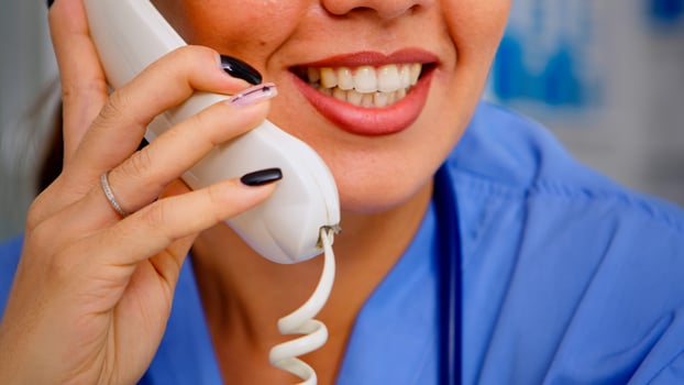 Close up of specialist practitioner talking at phone during telehealth communication, helping patient with mild health conditions. Healthcare physician in uniform, doctor assistant offering consultation photo