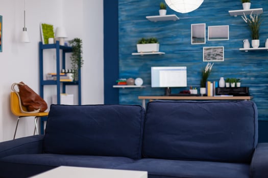 Modern living room with nobody in with blue furniture and walls, beautiful decorated. Pretty simple decor of apartment. Elegant retro decoration, cozy. photo