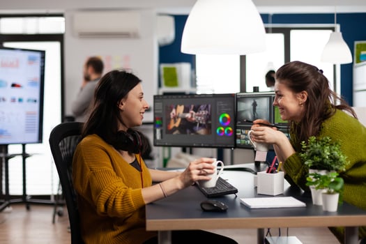 editors team talking in front of pc working at client creative project using post production software. Creative people editing film montage in digital multimedia company photo