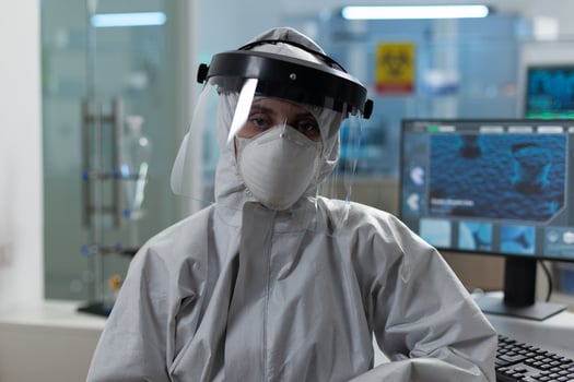 Portrait of scientist woman wearing protective medical equipment against coronavirus working at virus investigation in biochemial hospital laboratory. Researcher virology developing medicine vaccine photo