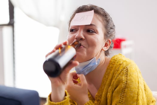 Happy woman gesturing playing name game with multiethnic friends having sticky notes on forehead wearing face mask keeping social distancing. Diverse group of people having fun at new normal party photo