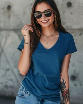 A beautiful woman in a blue V-neck t-shirt poses for a casual photoshoot photo
