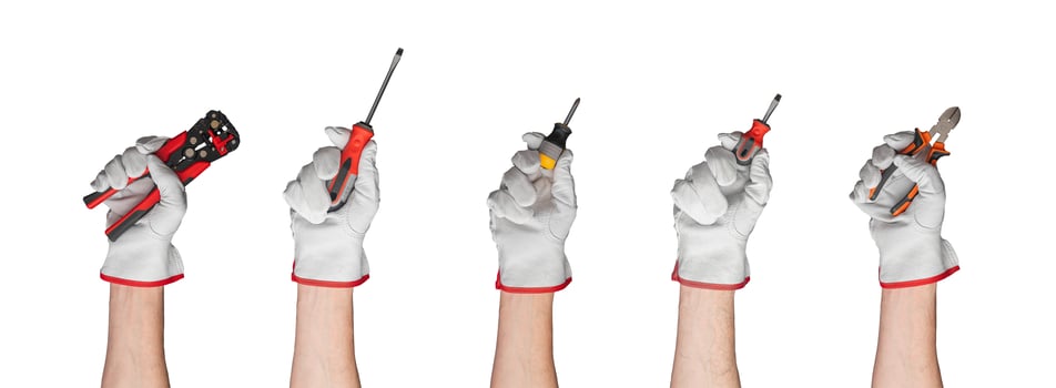 Assorted hand tools including screwdrivers, pliers, and crimping tool. Essential for construction, photo