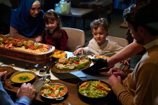 In this captivating aerial view, delicious food adorned with Ramadan decorations, including dates and meat, awaits the arrival of an European Islamic family, promising a festive and flavorful iftar photo