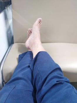 human legs resting on the train seat. barefoot on the seat during the train journey. relieve fatigue photo