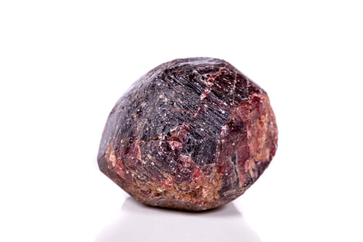 Macro of a mineral garnet stone on a white background photo