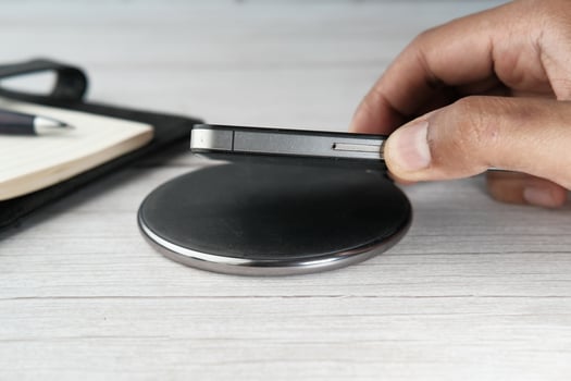 charging Smartphone Using Wireless Charging Pad, photo