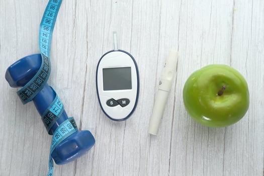 blood sugar measurement for diabetes with apple and dumbbell photo