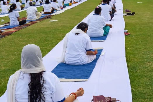 Group Yoga exercise session for people of different age groups at cricket stadium in Delhi on International Yoga Day, Big group of adults attending yoga session photo