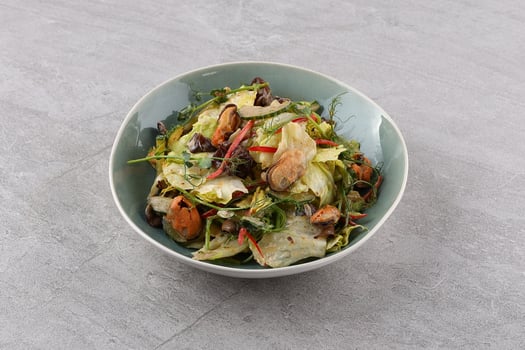Salad with mussel, iceberg lettuce, dressed with top selling nut sauce for restaurant and cafe photo