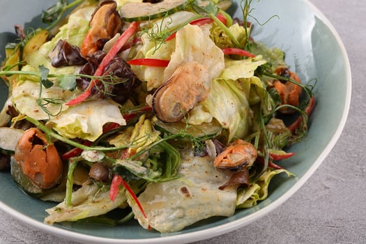 Salad with mussel, iceberg lettuce, dressed with top selling nut sauce for restaurant and cafe photo
