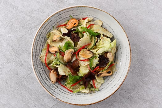 Salad with mussel, iceberg lettuce, dressed with top selling nut sauce for restaurant and cafe photo