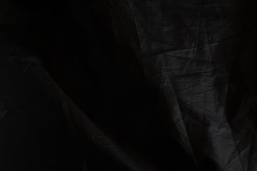 Black crumpled paper with shadow for background. wrinkled surface, design, wallpape photo