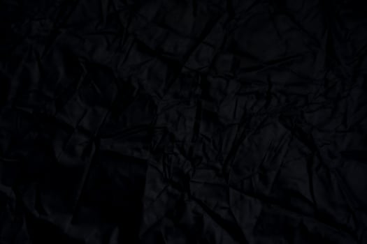 Black crumpled paper with shadow for background. wrinkled surface, design, wallpape photo