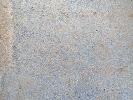 A white wall with a hole in it. The wall is cracked and has a rough texture photo