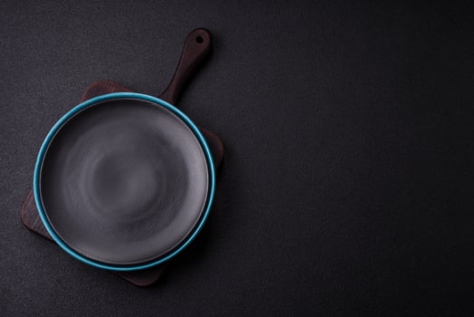 Empty ceramic round plate on dark textured concrete background photo