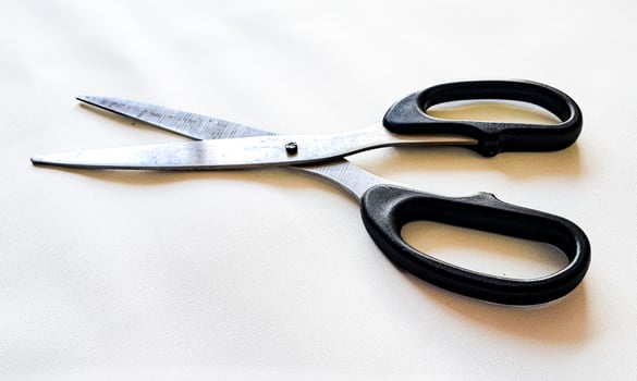 A pair of scissors with a black handle and a white background photo